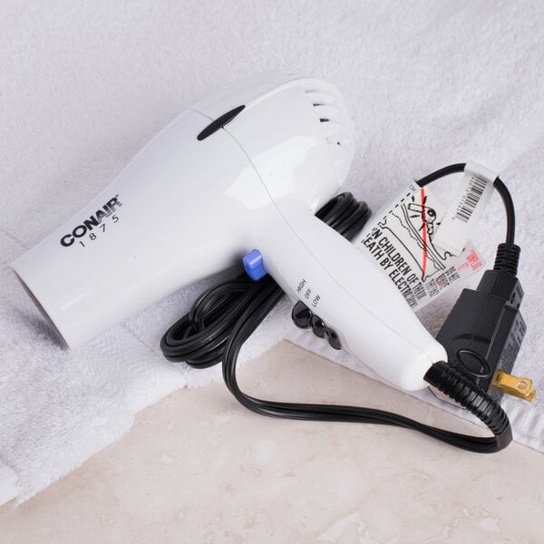 A white Conair compact hair dryer with a cord and plug.