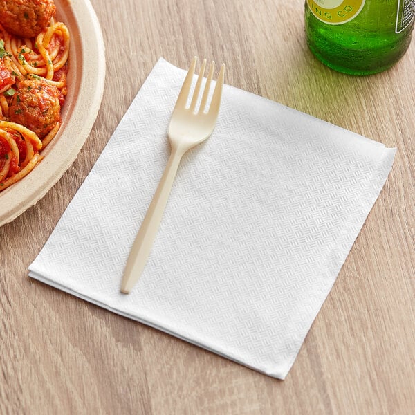 A white fork on a 12" x 12" white premium luncheon napkin.