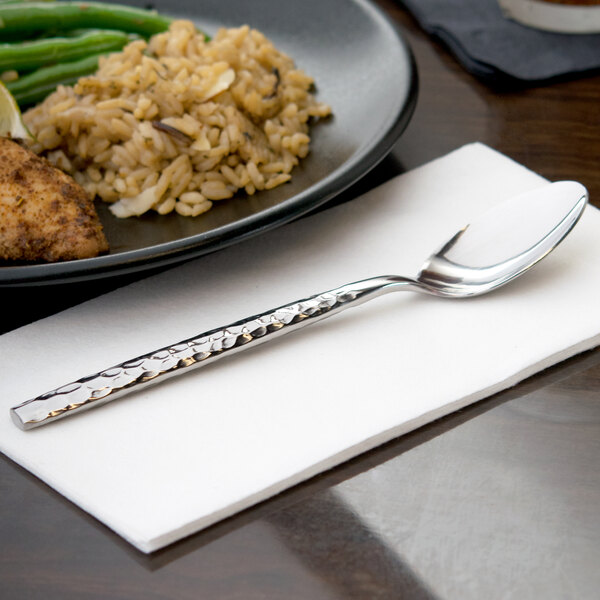 A plate of food with a 10 Strawberry Street stainless steel teaspoon on a napkin.