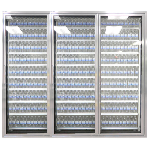 A row of Styleline walk-in cooler doors with shelving holding water bottles.