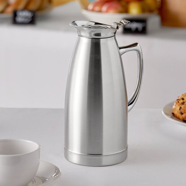 A silver metal Choice stainless steel thermal beverage server on a table.