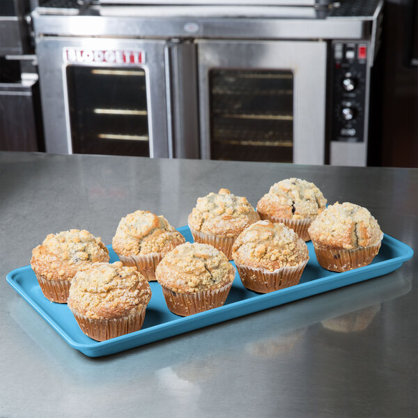 A Sky Blue MFG Tray Supreme Display Tray of muffins on a counter.