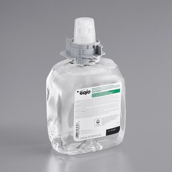 A clear plastic bottle of GOJO Green Certified fragrance-free foaming hand soap with a white label.