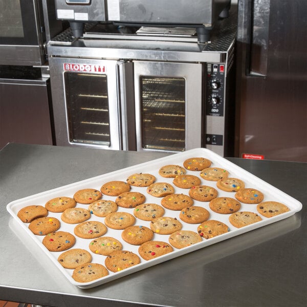 A white MFG Tray Supreme Display Tray with cookies and multicolored sprinkles on a counter.