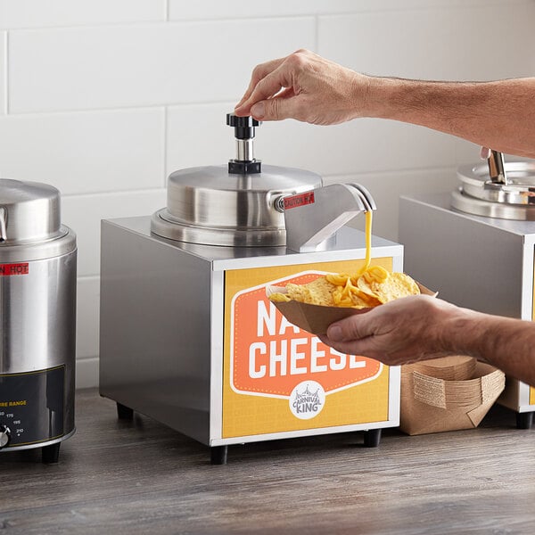 A person using a Carnival King condiment warmer to pour liquid cheese onto a bowl of chips.