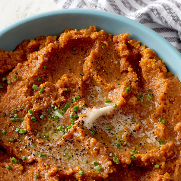A bowl of Bruce's mashed sweet potatoes with garlic and parsley.