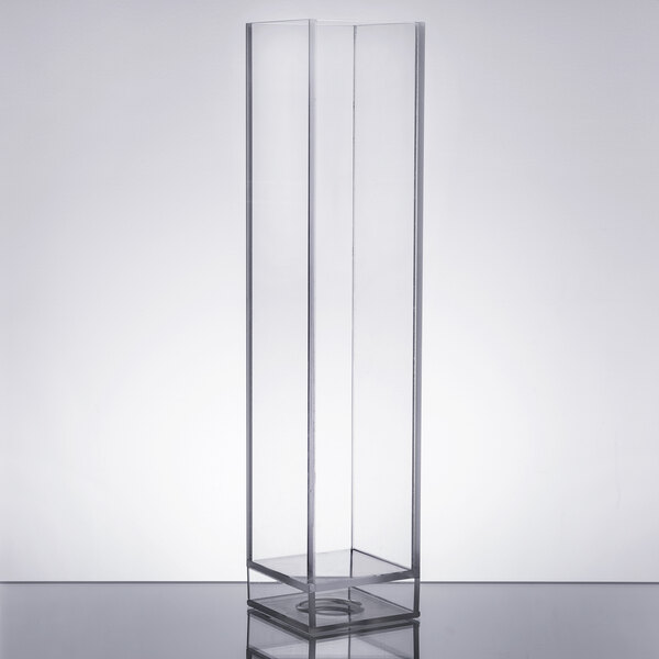 A clear rectangular object with a stand inside a white room.