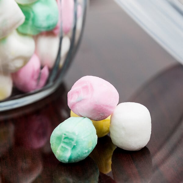 Assorted pastel round balls of marshmallow candies.