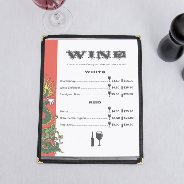 Asian themed dragon menu paper on a table with wine glasses.