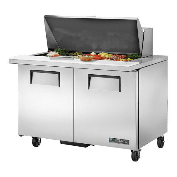 A True stainless steel refrigerated sandwich prep table with two doors on a counter.