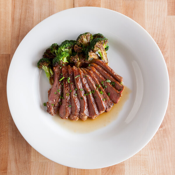 A 10 Strawberry Street Royal White porcelain dinner plate with meat and broccoli on it.