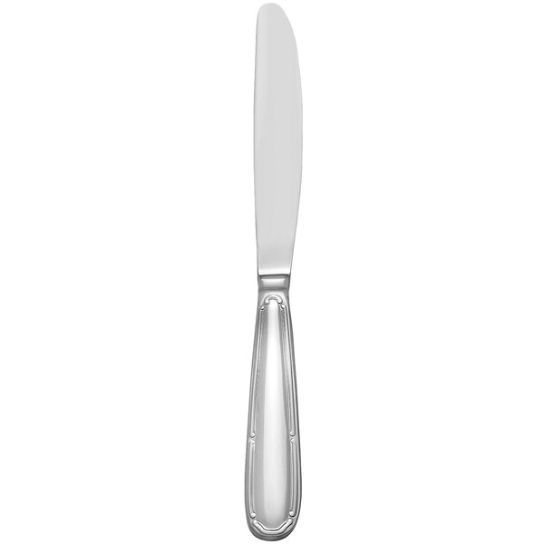 A silver dinner knife with a white handle.