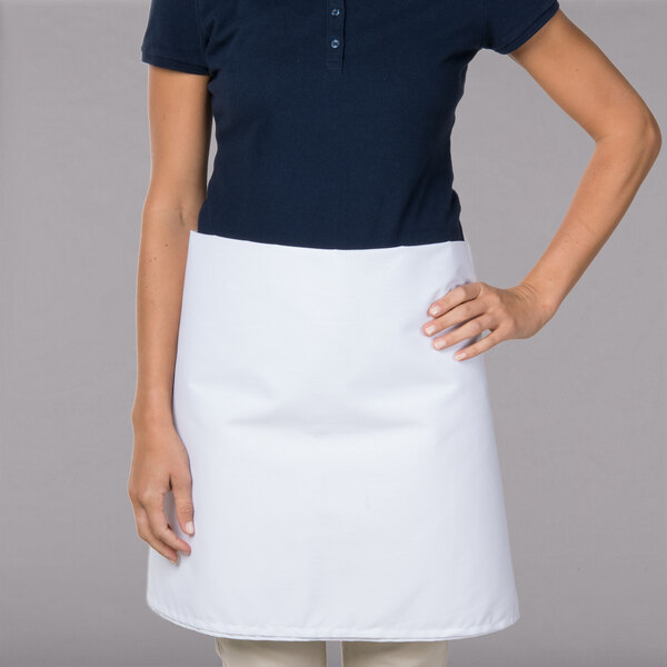 A woman wearing a white Intedge waist apron.