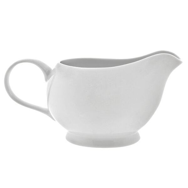 A white Royal White porcelain gravy boat with a handle.