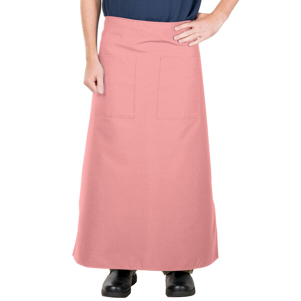 A person wearing a mauve Intedge bistro apron with pockets.