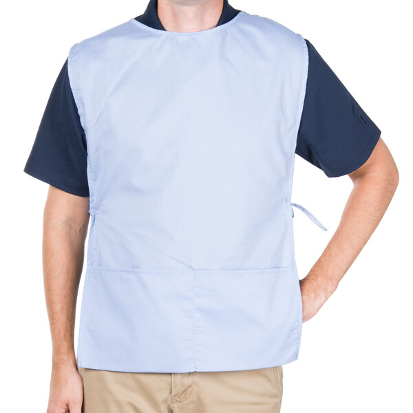 A man wearing a light blue Intedge cobbler apron with black accents.