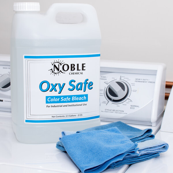 A white Noble Chemical bottle of Oxy Safe concentrated bleach with blue text.
