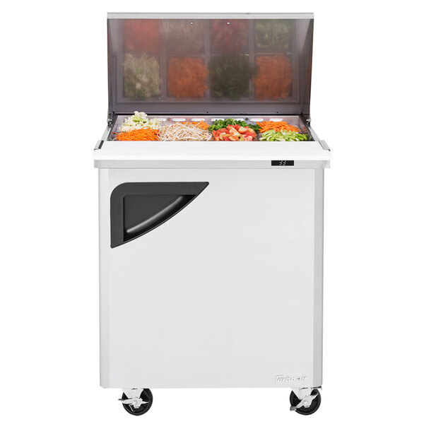 A white Turbo Air refrigerator with food in it.