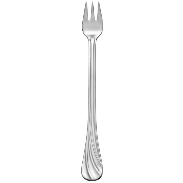 A silver cocktail fork with a white handle.