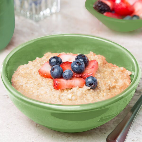 A close-up of a Libbey sage green oatmeal bowl filled with oatmeal and fruit.