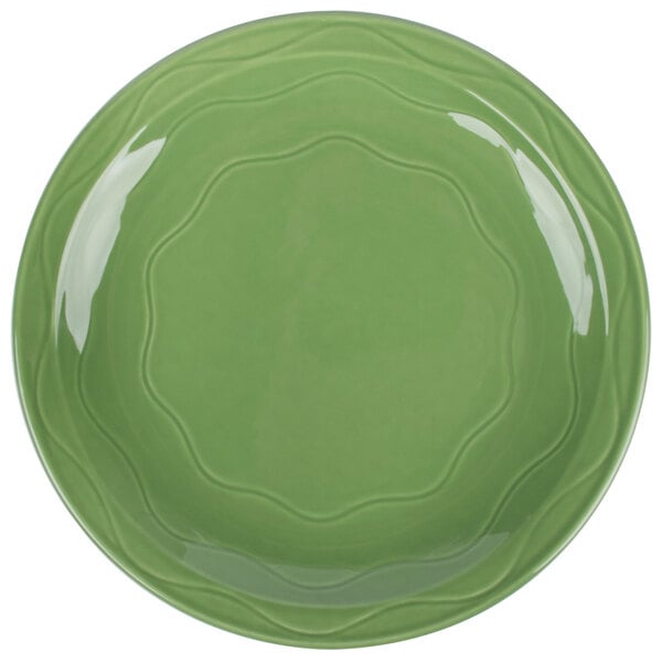 A close-up of a green Libbey Cantina porcelain plate with a wavy design.