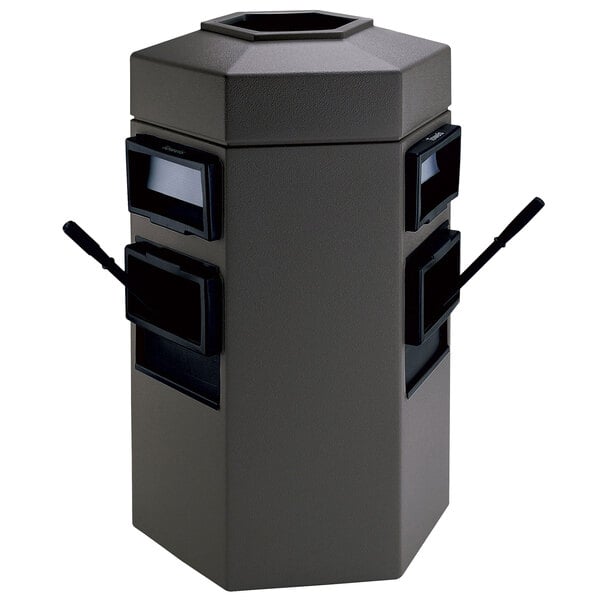 A grey hexagonal waste container with paper towel dispensers and windshield wash stations.