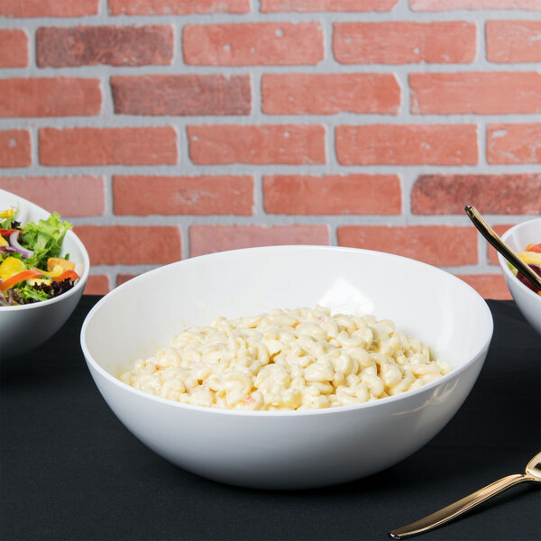 A group of Tablecraft Sierra melamine bowls filled with macaroni salad, salad, and fruit.