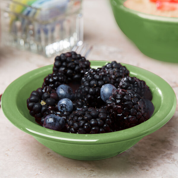 A close up of a Libbey Cantina porcelain bowl filled with blackberries and blueberries.
