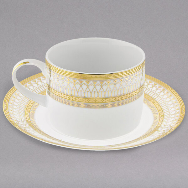 A white and gold Iriana porcelain teacup and saucer with a gold design.