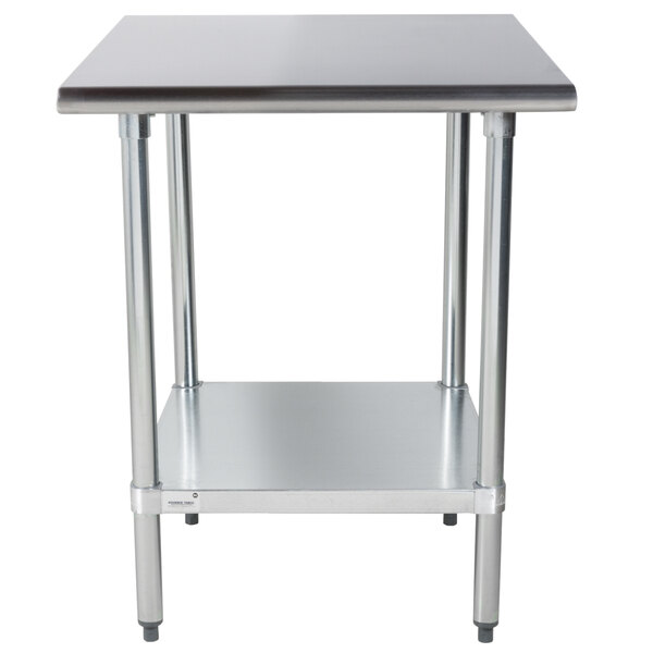 A stainless steel Advance Tabco work table with a galvanized shelf.