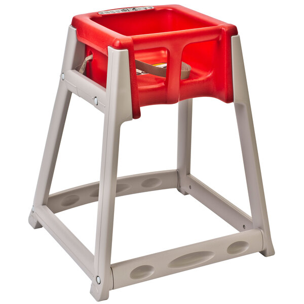 A red high chair with a beige base and seat.
