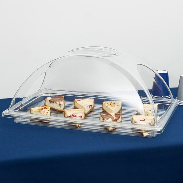 A clear plastic Cambro tray with a piece of cheesecake on it.