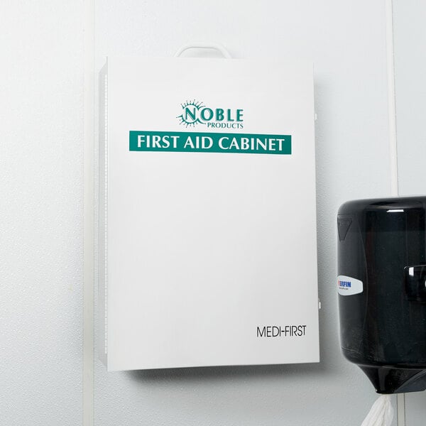 A white Lavex first aid cabinet with green text on it.