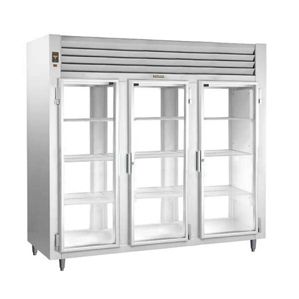 A white Traulsen three section glass door reach-in refrigerator with open glass doors.
