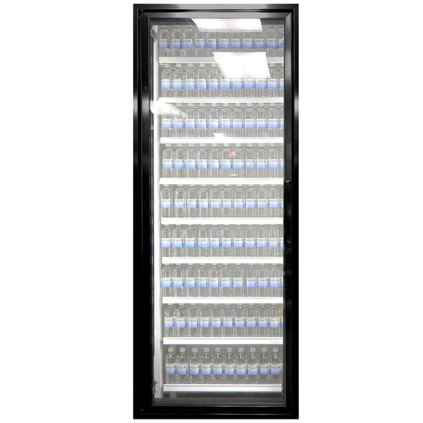 A black Styleline walk-in freezer door with glass and shelving holding water bottles.