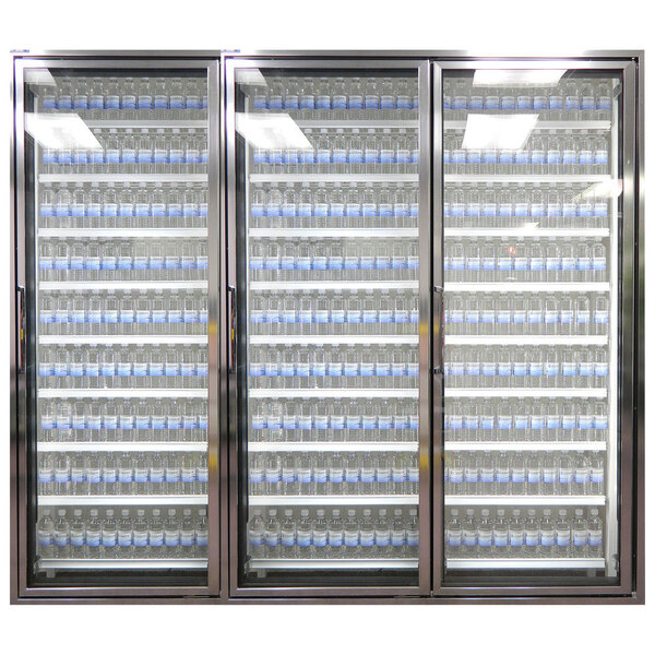 Three Styleline glass walk-in cooler doors with shelving inside holding water bottles.