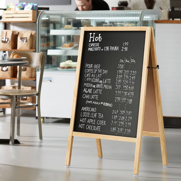 A natural oak wood A-Frame menu board with white writing on it.