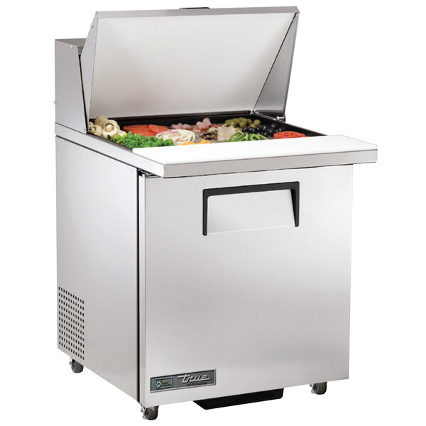 A True stainless steel refrigerated sandwich prep table with a large compartment full of food.