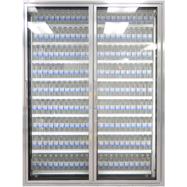 A Styleline walk-in freezer merchandiser with glass doors holding bottles of water.