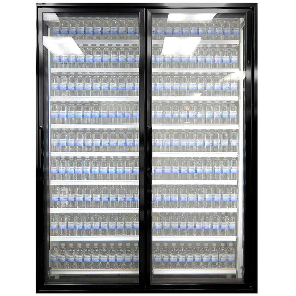 A Styleline walk-in freezer merchandiser with glass doors full of water bottles.