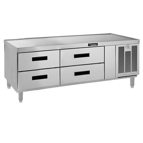 A stainless steel counter with 4 refrigerated drawers.