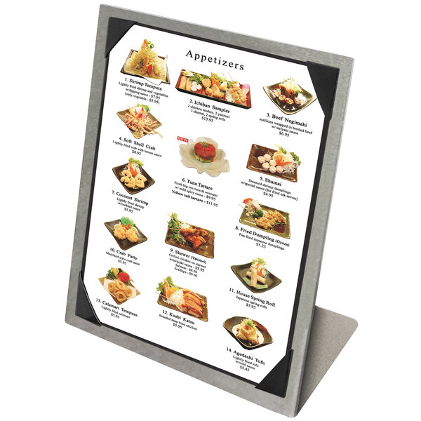 A Menu Solutions aluminum menu tent with picture corners holding a menu of food on a stand.
