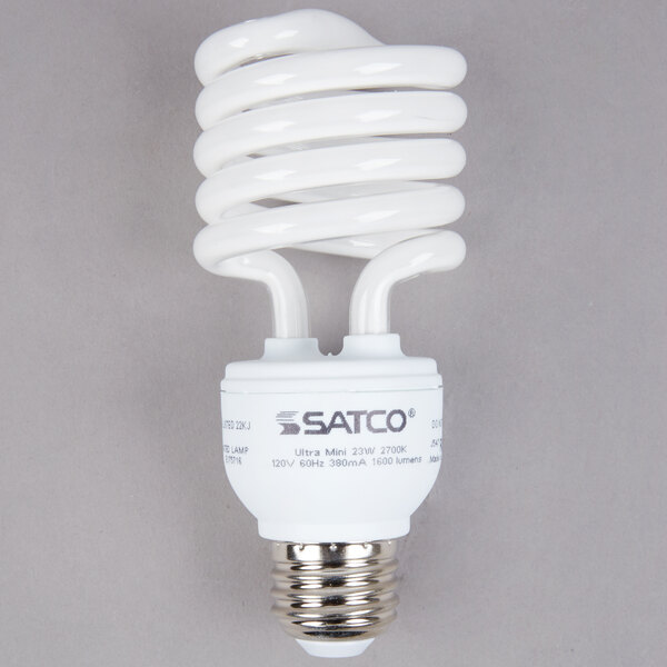 A close-up of a white Satco spiral light bulb.