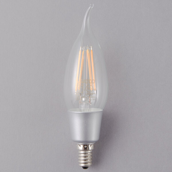 A close-up of a Satco clear LED light bulb with a filament.