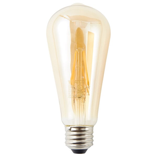 A close-up of a Satco transparent amber LED light bulb with a clear light bulb inside.