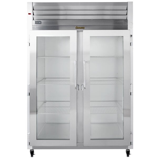 A Traulsen reach-in refrigerator with double glass doors on a stainless steel cabinet.