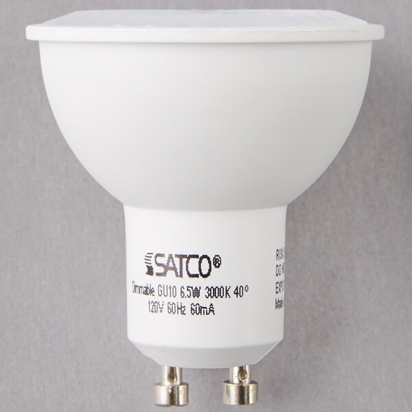 A Satco MR16 LED light bulb with black text on it.