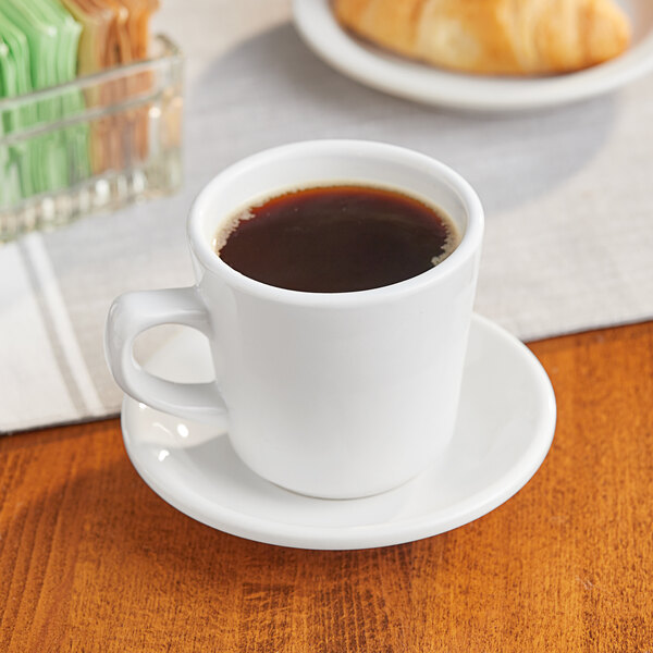An Acopa tall cup of coffee on a table.
