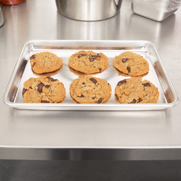A Vollrath Wear-Ever bun pan filled with cookies on a table.