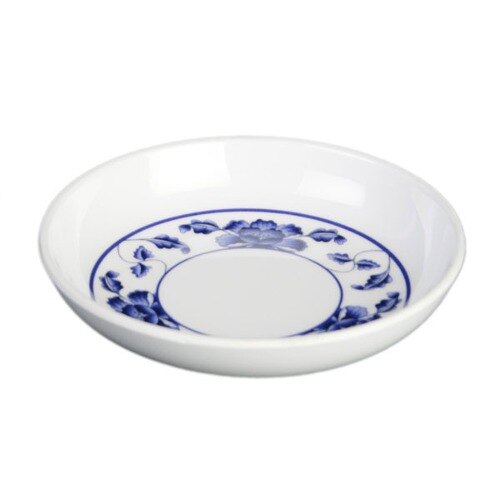 A white Thunder Group sauce dish with blue lotus flowers on it.